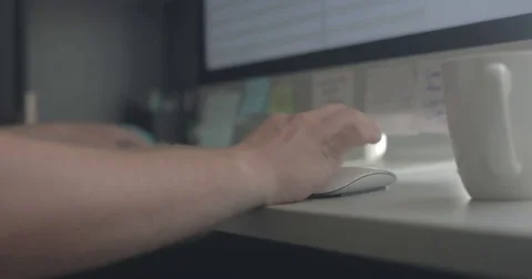 Man scrolls with computer mouse in home office Stock Footage