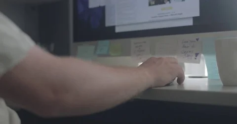 Man scrolls with computer mouse in home office Stock Footage