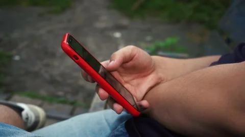 Man scrolls the phone while on the street Stock Footage 158284369