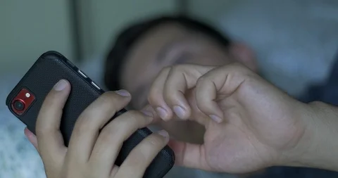 Man Scrolls through Phone in Bed Stock Footage 114702801