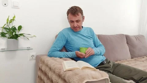 A man scrolls through the screen of a mobile phone with a green chroma key Stock Footage 276916334
