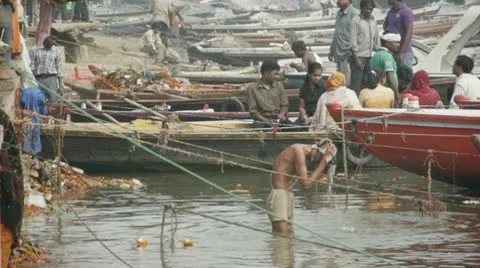 Man Scrubs &amp; Washes Head in Ganges Stock Footage 10604964