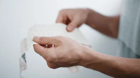 Man Scrutinizing Lengthy Store Receipt Stock Footage 312475347