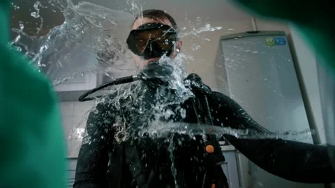 Man with a scuba diving opens the door of a broken washing machine Stock Footage 151650116