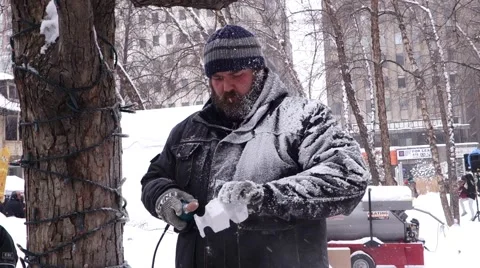 Man sculpting ice using a grinder Stock Footage 47887686