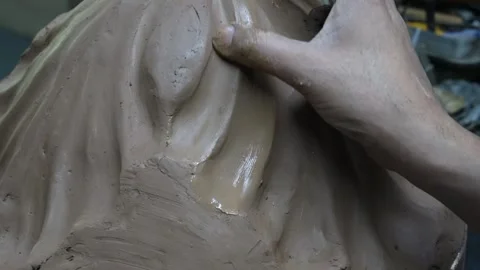 A man sculpting a model with hands on clay. Wet clay material for sculpting.. Stock Footage 244741368