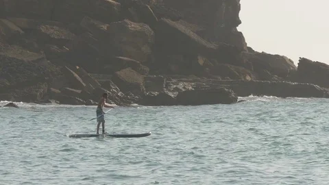 Man in sea paddle surf slow motion Stock Footage