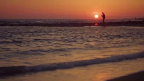 Man on the sea, walking on the beautiful beach in sunset. Sand, seaside. Stock Footage 80438965