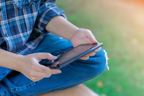 The man search online using a digital tablet at the front yard. Stock Photos