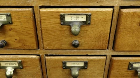 A man searches archive storage filing cabinet system Видео 70257564