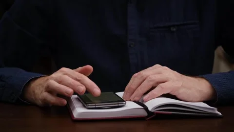 Man searches for information on Internet using smartphone. front view. close-up. Stock Footage 303022925