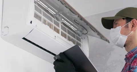 Man searches model of conditioner on tablet and checks Stock Footage 228568810