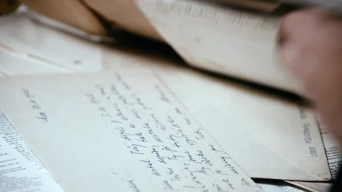 Man searches through pile of old documents and letters. Close up. Stock Footage 116605966