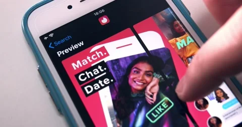 Man searches Tinder app in App Store and watches its page on iPhone Stock Footage 146622089