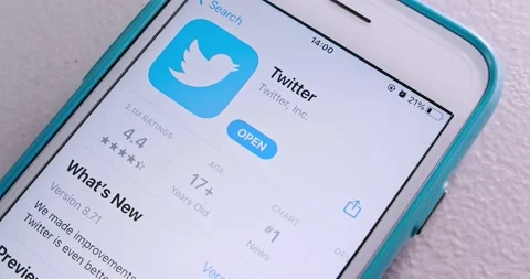 Man searches Twitter app in App Store and watches introduction on iPhone Stock Footage 156795640