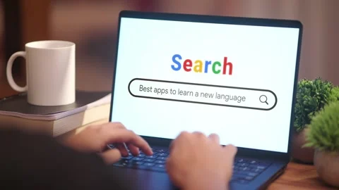 MAN SEARCHING BEST APPS TO LEARN A NEW LANGUAGE ON INTERNET Stock Footage 308127074