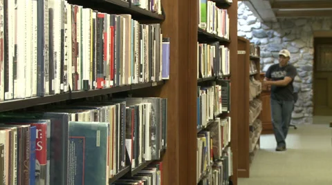 Man searching bookshelf in library (2 of 4) Stock Footage 32029704