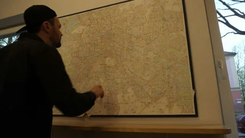 Man Searching For A Place On Wall Map Stock Footage 89485850