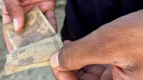 Man Searching Pocket and Finding Torn Ten Rupee Note | Financial Struggle Stock Footage 319447835