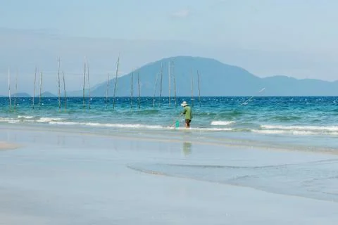 Man searching small shell from the beach Stock Photos
