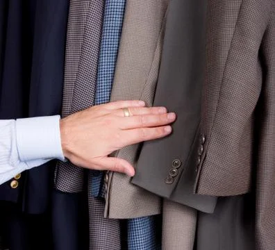 Man searching through suits Stock Photos