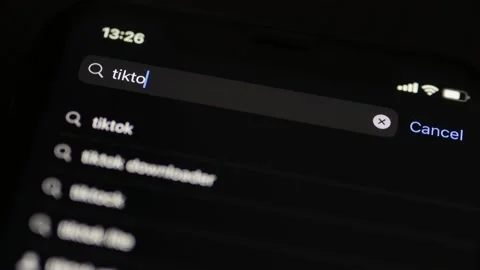 Man searching for TikTok app in App Store on iPhone. TikTok app. Stock Footage 239088907