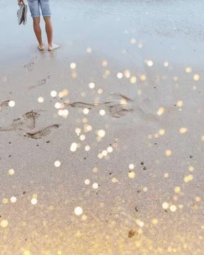 Man on the seashore with glitters Stock Photos