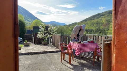 Man Seasoning Fresh Fish on Rustic Outdoor Table in Countryside Video stock 333523311