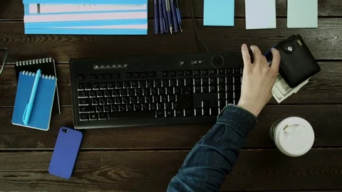 A man seat on a computer keyboard on his desk. Stock Footage 82014309