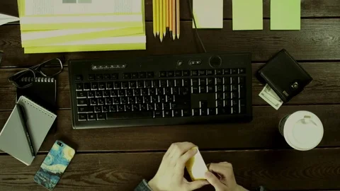 A man seat near a computer keyboard on his desk and take bank card. Stock Footage 82011009