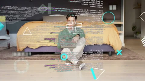 Man seated tapping tablet in bedroom, starting tech code overlays building then Stock Footage 333873257