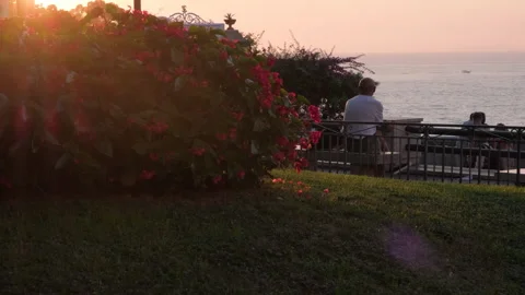 Man seating on a bench enjoying the sunset on a terrace at Sorrento, summer day Stock Footage 248535192