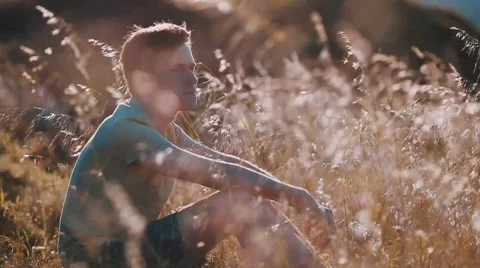 Man is seating in the wheat field Video stock 46239097