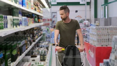 Man in the section of alcohol drinks Stock Footage 142968348