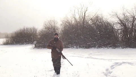 Man securing a reserve. man walking on a snowy day Stock Footage 99982817