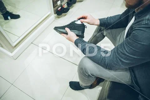 Man seek new sneakers in store. shopping concept. shoes fashion buy shopping Stock Photos