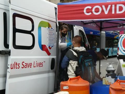 A man is seen having a COVID test performed at a mobile testing station Stock Photos