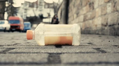 A man sees a plastic bottle on the ground and picks it up Stock-Footage 126033192