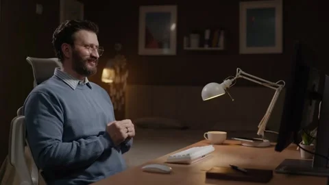 Man sees something positive on his computer screen and rejoices at his success Video stock 337645409