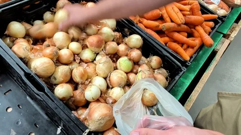 Man Selecting Fresh Brown Onions In Supermarket Produce Department Filling Stock Footage 340643974
