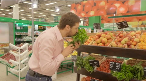 Man selecting fresh herbs in grocery store department. Stock Footage 63374899