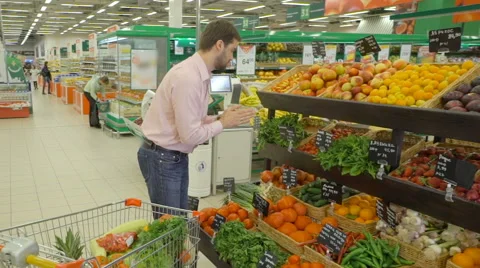 Man selecting fresh peppermint in grocery store department. Stock Footage 63377221