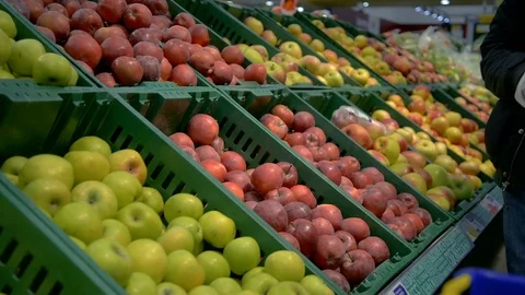 Man selecting fresh red apples in grocery store department Stock Footage 72916015