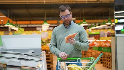 Man selecting frozen red fish in a supermarket freezer Stock Footage 304088588