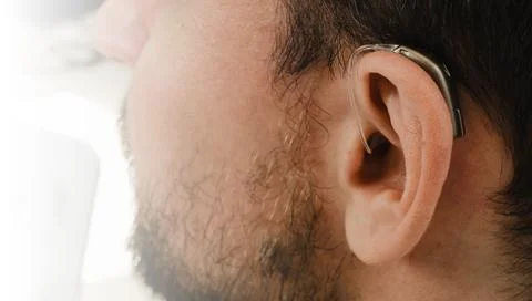 Man selecting modern compact hearing aids Stock Photos