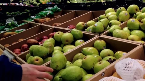 Man selecting pear in grocery store Stock Footage 48120583