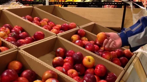 Man selecting plum in grocery store Stock Footage 47429235