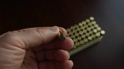 Man selects a .357 caliber pistol bullet. (color) Stock Footage 61715887