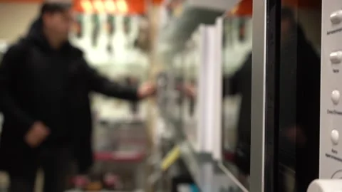 A Man Selects A New Microwave In An Appliance Store Stock Footage 156880888
