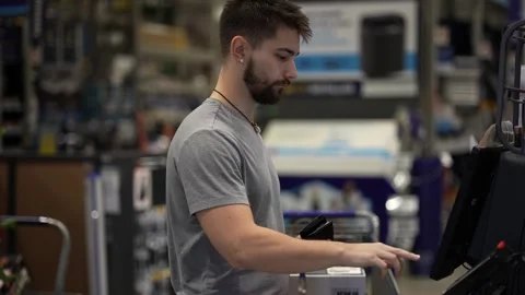 Man at self checkout in hardware store. Stock Footage 280190235